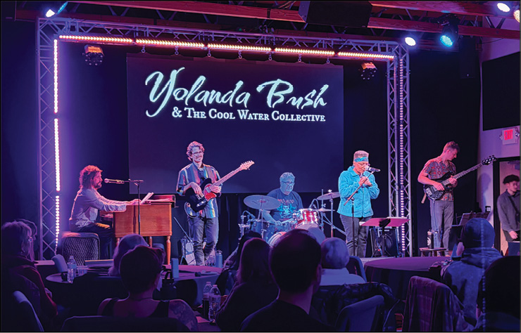 A band playing to a full room at a Oneonta venue